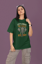 Person wearing a green t-shirt with an elephant graphic and text on a purple background