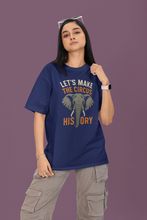 Person wearing a blue t-shirt with an elephant graphic and text on a purple background