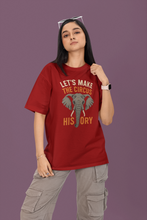 Person wearing a red t-shirt with an elephant graphic and text on a purple background
