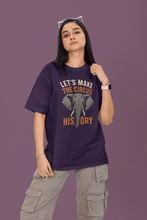 Person wearing a purple t-shirt with an elephant graphic and text on a purple background