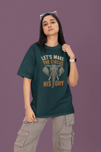 Person wearing a green t-shirt with an elephant graphic and text on a purple background