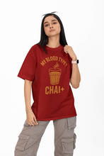 Person wearing a red t-shirt with yellow text and graphics on a white background