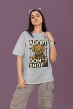 Person wearing a t-shirt with 'Adopt Don't Shop' graphic on a purple background