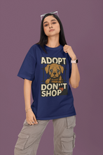 Person wearing a blue t-shirt with an 'Adopt Don't Shop' graphic on a purple background