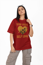 Person wearing a red t-shirt with a graphic and text on a white background