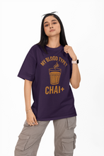 Person wearing a purple t-shirt with yellow text and graphics on a white background