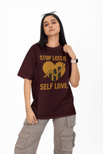 Person wearing a maroon t-shirt with a heart and text design on a white background
