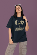 Person wearing a black t-shirt with a graphic and text on a purple background