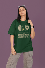 Person wearing a green t-shirt with a brain and heart design and text on a purple background