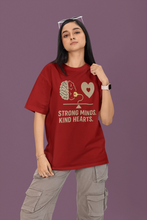 Person wearing a red t-shirt with a brain and heart design and text on a purple background