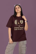 Person wearing a t-shirt with a brain and heart design and text on a purple background