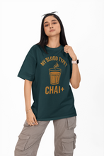 Person wearing a green t-shirt with a unique design on a white background