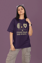 Person wearing a purple t-shirt with a brain and heart design and text on a purple background