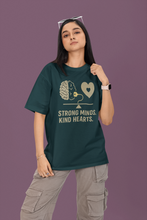 Person wearing a green t-shirt with a brain and heart design and text on a purple background