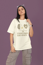 Person wearing a t-shirt with a graphic and text on a purple background