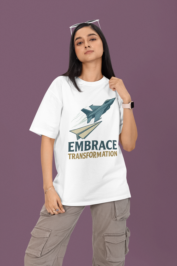 Person wearing a white t-shirt with a graphic and text 'Embrace Transformation' on a purple background