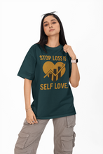 Person wearing a green t-shirt with a motivational message on a white background